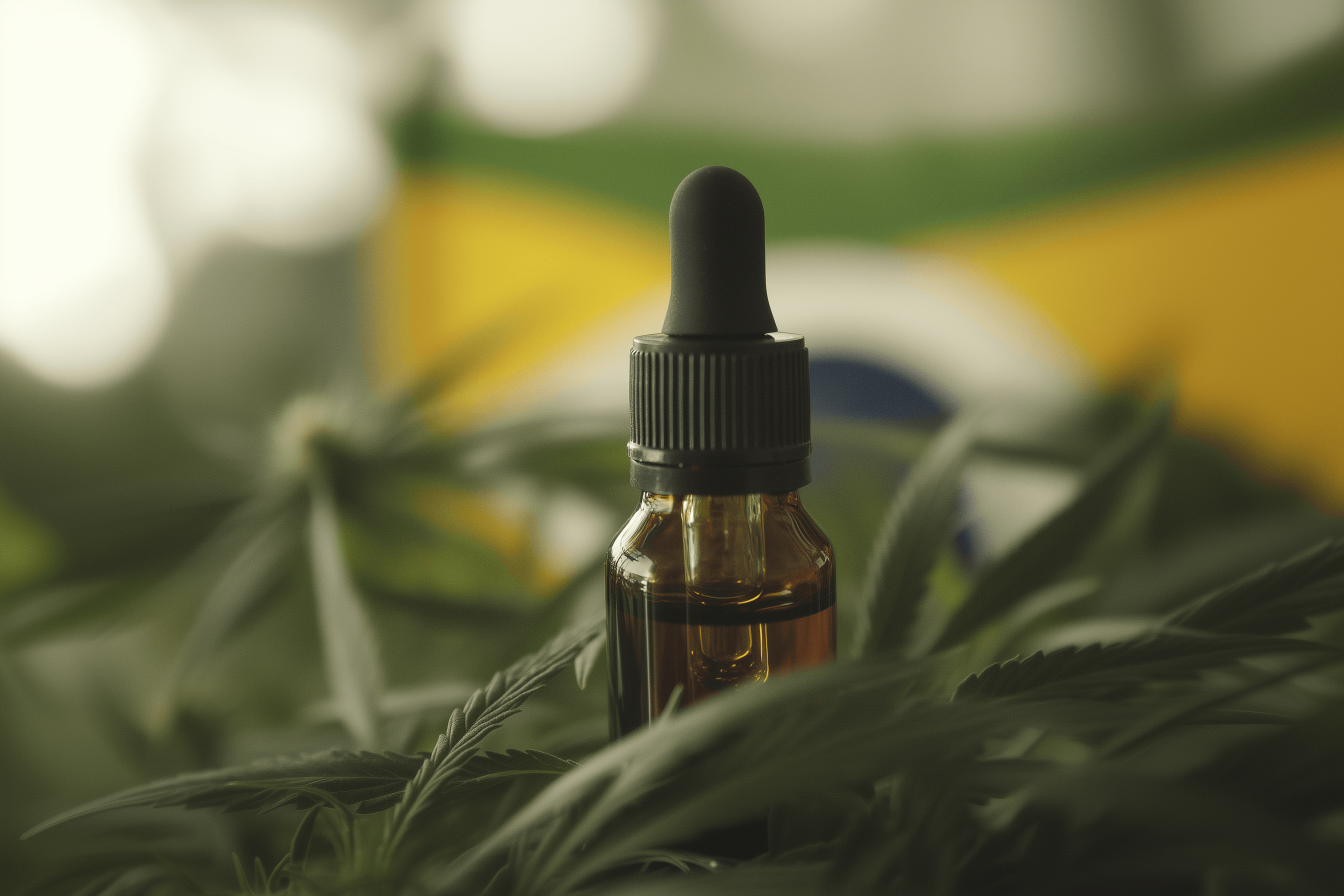 Frasco de óleo de cannabis em meio a folhas, com a bandeira do Brasil ao fundo, ilustrando uso medicinal.